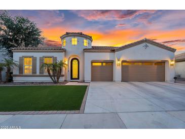 Stunning single-story home with a well-manicured lawn, desert landscaping, and a three-car garage at 4206 E Blue Ridge Pl, Chandler, AZ 85249