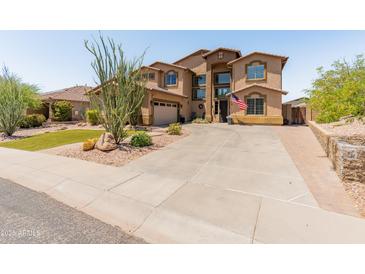 Beautiful two-story home featuring lush xeriscape, a large driveway, and an inviting front entrance at 4418 W Yoosooni Dr, New River, AZ 85087