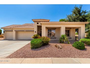 Charming single-story home with a well-maintained landscape and a spacious three-car garage at 5102 S Peachwood Dr, Gilbert, AZ 85298