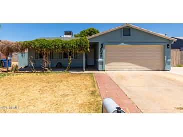 Charming single-story home with a well-maintained lawn and a cozy, covered porch entrance at 8042 W Mariposa Dr, Phoenix, AZ 85033