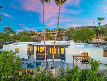 Stunning exterior with a private pool, mature landscaping, and a pergola for outdoor entertaining at 908 W Pershing Ave, Phoenix, AZ 85029