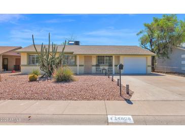 Charming home showcasing desert landscaping and a well-maintained front yard with an attached one-car garage at 14808 N 37Th Way, Phoenix, AZ 85032