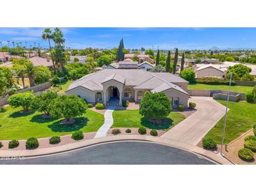 Expansive front yard featuring mature trees, lush landscaping, and a well-maintained lawn leading to the beautiful home at 1940 N Stevens Cir, Mesa, AZ 85205