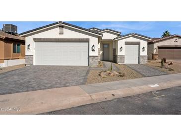 Charming single-story home with a three-car garage and brick-paved driveway, nestled in a desirable neighborhood at 2249 N Shannon Way, Mesa, AZ 85215