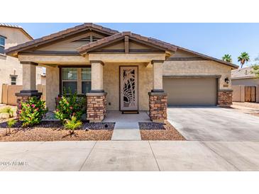 Charming single-story home featuring a decorative front door and well-maintained desert landscaping at 2747 S 85Th Way, Mesa, AZ 85209