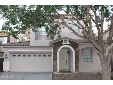Charming two-story home featuring a stone-accented entrance and a well-maintained front yard at 4145 E Santa Fe Ln, Gilbert, AZ 85297