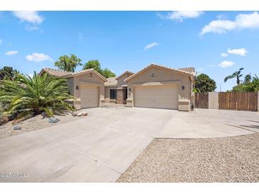 Charming home with a three car garage, desert landscaping, and a spacious driveway at 422 E Kaibab Pl, Chandler, AZ 85249