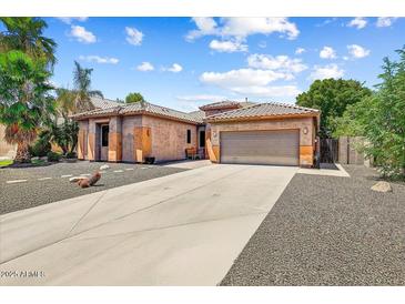 Charming single-story home with a spacious driveway and desert landscaping at 776 W Carob Way, Chandler, AZ 85248