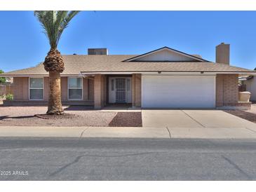 Charming single-story home featuring a two-car garage and low-maintenance landscaping at 10326 W Harmont Dr, Peoria, AZ 85345