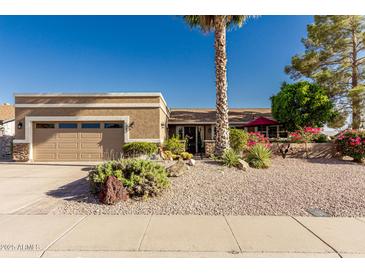 Charming single story home featuring a well-maintained yard with desert landscaping and an attached two-car garage at 1087 Leisure World --, Mesa, AZ 85206