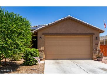 Charming home featuring a two-car garage, low maintenance landscaping, and a cozy, inviting facade at 1662 E Kingman Pl, Casa Grande, AZ 85122