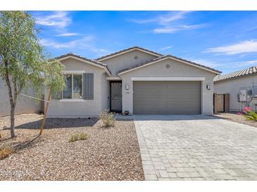 Beautiful single-story home with low maintenance desert landscaping, charming architectural details, and a spacious two-car garage at 1960 N Loretta Pl, Casa Grande, AZ 85122