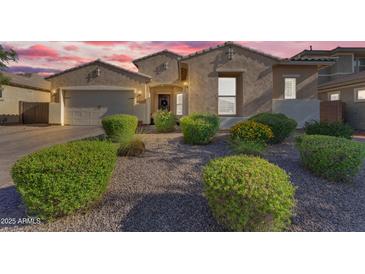 Charming single-story home featuring manicured landscaping and a welcoming entrance in a desirable neighborhood at 2459 E Lindrick Dr, Gilbert, AZ 85298