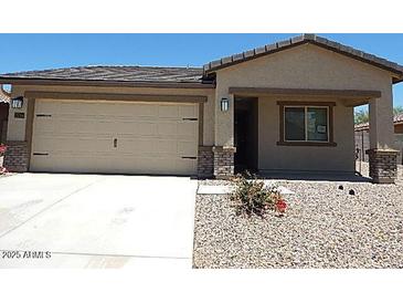 Charming single-Gathering home with a two-car garage and low maintenance desert landscaping at 25744 W Winston Dr, Buckeye, AZ 85326