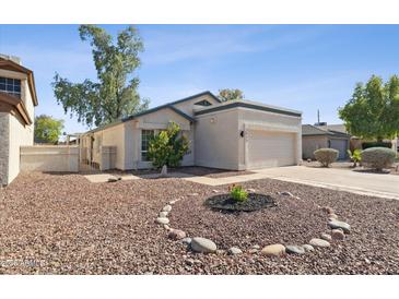 Charming single-story home featuring a well-kept yard with decorative rock and an attached two-car garage at 3955 W Cindy St, Chandler, AZ 85226