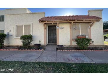 Inviting front entrance with a red tiled porch roof and security door at 8063 N 31St Ln, Phoenix, AZ 85051
