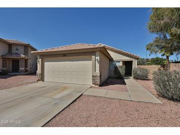 Charming single-story home featuring a two-car garage and neutral-colored exterior, enhanced by a well-maintained yard at 12117 N 127Th Dr, El Mirage, AZ 85335