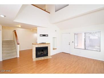 Bright living room with a fireplace and large window for natural light at 16644 N 33Rd St # 101, Phoenix, AZ 85032