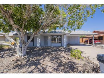 Charming single-story home featuring desert landscaping, attached carport, and a covered entryway at 17848 N 34Th Ln, Phoenix, AZ 85053