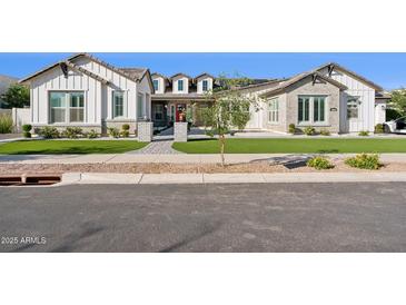 Beautiful single-story home features a manicured lawn, sidewalk, and neutral color palette at 19910 E Vallejo St, Queen Creek, AZ 85142