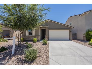 Charming single-Gathering home showcasing a well-maintained yard and a two-car garage at 297 W Nikita Dr, San Tan Valley, AZ 85140