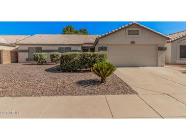 Charming single-story home with a well-maintained gravel yard and a two-car garage at 3343 W Lone Cacuts Dr, Phoenix, AZ 85027