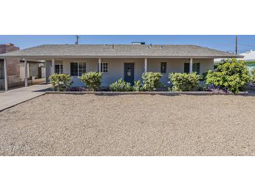 Charming single-story home featuring a gravel front yard and a covered entryway at 3347 W Roma Ave, Phoenix, AZ 85017