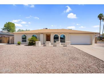 Charming single-story home with a well-maintained yard and beautiful desert landscaping at 3514 W Helena Dr, Glendale, AZ 85308