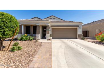 Charming single-story home featuring a well-manicured front yard and inviting covered porch at 4067 W Maggie Dr, San Tan Valley, AZ 85144
