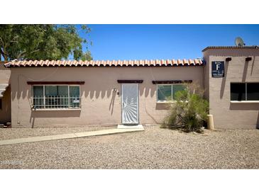 Charming condo featuring a traditional southwestern style with a tile roof and secure front door at 4625 W Thomas Rd # 48, Phoenix, AZ 85031