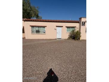 Charming single-story home with a well-maintained yard and a desert landscape at 4625 W Thomas Rd # 48, Phoenix, AZ 85031