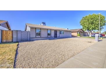 Charming single-story home featuring low-maintenance gravel landscaping and a well-kept facade at 7332 W Desert Cove Ave, Peoria, AZ 85345
