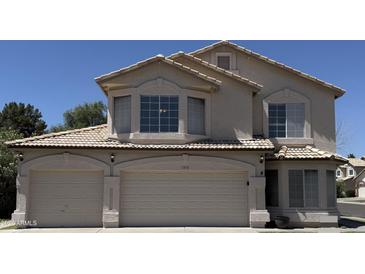 Inviting two-story home featuring a three-car garage and well-maintained landscaping at 1212 W Glenmere Dr, Chandler, AZ 85224