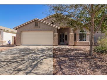 Charming single-story home featuring a two-car garage and low-maintenance landscaping at 1619 E Aspen Ave, Buckeye, AZ 85326