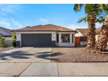 Charming single-story home with a well-maintained front yard and attached two-car garage at 1736 E Bluefield Ave, Phoenix, AZ 85022