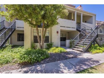 Charming condo building with stairs, stucco exterior, and lush green landscaping at 2333 E Southern Ave # 1023, Tempe, AZ 85282