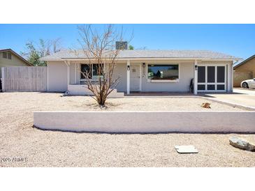 Charming single-story home featuring a well-maintained front yard and an attached garage at 3203 W Libby St, Phoenix, AZ 85053