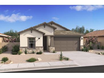 Charming single-story home with a two-car garage and beautiful desert landscaping in the front yard at 42400 W Peters Dr, Maricopa, AZ 85138