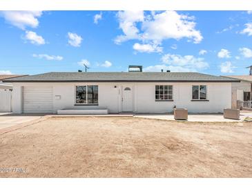 Charming single-story home with a white facade, well-placed windows, and low-maintenance landscaping at 6223 W Earll Dr, Phoenix, AZ 85033