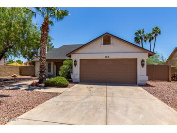 Charming single-story home with a well-maintained lawn, mature trees, and a two-car garage at 723 E Piute Ave, Phoenix, AZ 85024