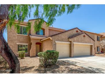 Charming two-story home featuring a two-car garage and well-maintained landscaping, perfect for Gathering living at 11871 W Sherman St, Avondale, AZ 85323