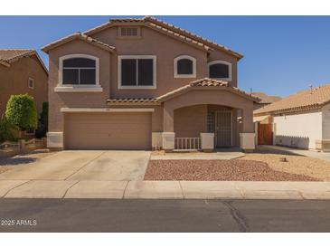 Two-story home featuring a covered porch, low maintenance front yard, and an attached two-car garage at 12720 W Cantenia Rd, Avondale, AZ 85392