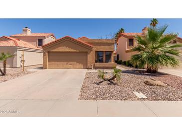 Charming single-story home with a two-car garage and desert landscaping in a residential neighborhood at 1534 E Mineral Rd, Gilbert, AZ 85234