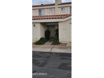 Charming townhome exterior with a tile roof and desert landscaping leading to the front door at 16021 N 30Th St # 113, Phoenix, AZ 85032