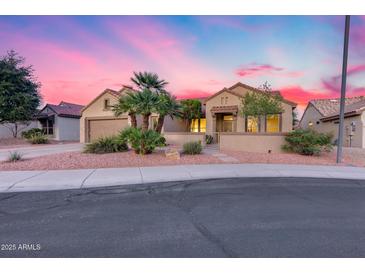 Charming single-story home featuring desert landscaping and a private gated courtyard entrance at 17911 N Adobe Mesa Ct, Surprise, AZ 85374