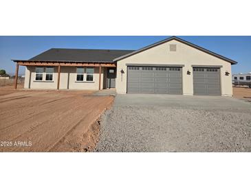 Beautiful single-story home featuring a spacious two-car garage and charming covered entry at 28151 N Faded Creek Dr, Florence, AZ 85132