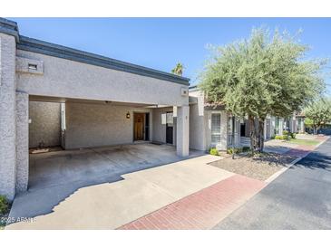 Beautiful home exterior with carport, desert landscaping and sidewalk access at 3415 N 36Th St # 3, Phoenix, AZ 85018
