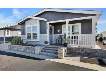 Charming home with well-maintained landscaping, front porch seating, and easy access with wide concrete steps at 650 N Hawes Rd # 2819, Mesa, AZ 85207