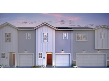 Modern townhome featuring a private garage and inviting front entrance at 7454 S 75Th Dr, Laveen, AZ 85339