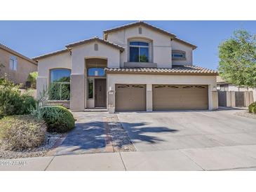 Inviting two-story home with a three car garage and meticulously maintained landscaping at 1441 E Folley Pl, Chandler, AZ 85225